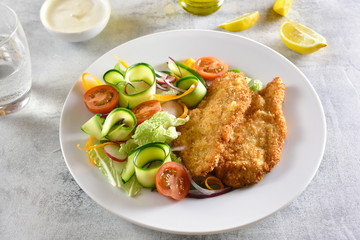 Vegetable salad and breaded chicken breast