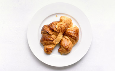 Croissants on plate, top view