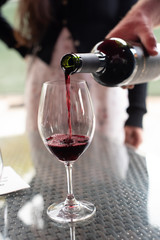 Pouring a glass of smooth red wine