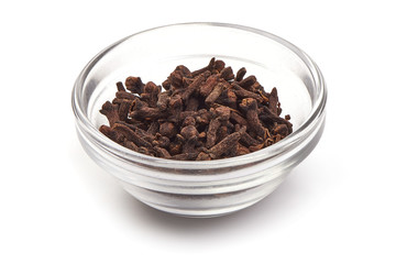 Dry Cloves Spice in a glass cup, close-up, isolated on white background.