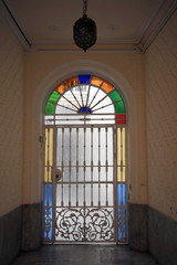 Glass door in the old building of the sea city of Cadiz