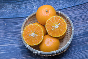 Fresh oranges on wooden table background.