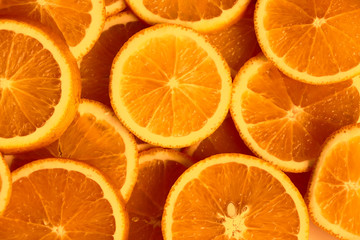 Top view of orange fruit slices, halves, cuts. Citrus fruits background.