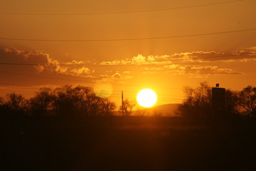Sunset in Kazahkstan Almaty in summer with trees and beautifyl sky clouds foto from passenger train