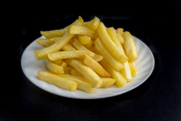 Potato fry or fries on dark background