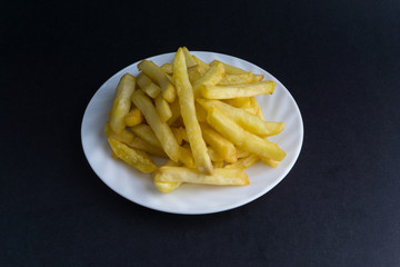 Potato fry or fries on dark background