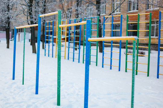 Chin-up bars covered with heavy snow close-up