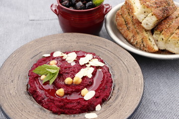 Beet hummus, olives and bread.