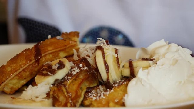 Waffles covers in bananans chocolate syrup wipe cream