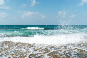 Waves on the beach on a bright sunny day