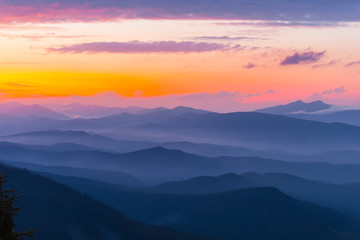 Fototapeta na wymiar evening mountain silhouette in a blue mist at the twilight