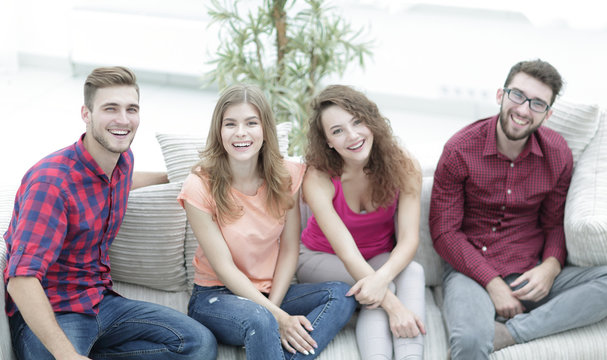 cheerful friends laughing in the living room.