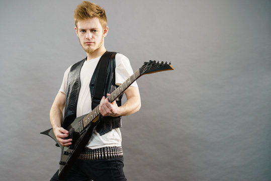 Young man playing electric guitar