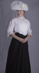 Edwardian woman in white blouse and black skirt