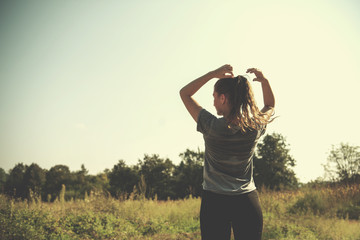 woman jogging along a country road