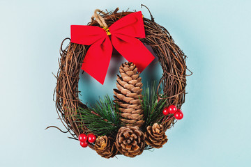 Single homemade christmas wreath on blue background