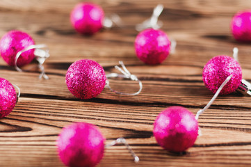 Lot of scattered red christmas balls on old wooden table