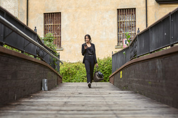 Girl is walking along bridge