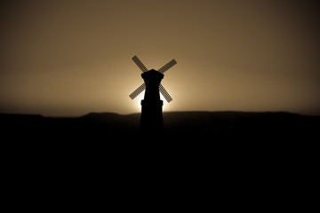 Traditional, Dutch windmill at a hill during a summer sunset. Decoration.