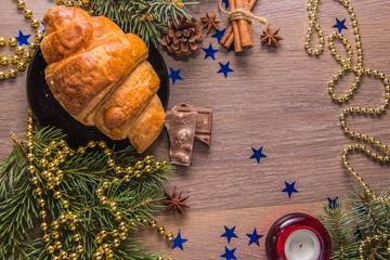 Fragrant croissant on a wooden background with Christmas-tree decoration - 226107066