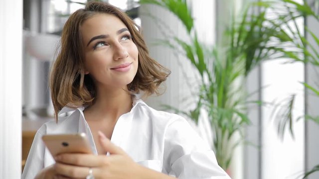 Smiling woman with smartphone