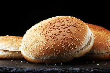 Fresh homemade burger buns on table.