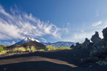 swirl of clouds over the volcanoes Ostry Tolbachik and Plosky Tolbachik. outcrops of the lava flow...