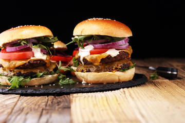 Tasty fresh meat burgers with salad and cheese. Homemade angus burger.