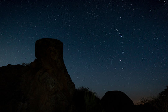 Shooting star. Night photography in the Natural Area of Barruecos. Extremadura. Spain.