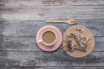 Chocolate with Macadamia-Almond cake Cake and hot coffee in pink cup on wooden table background.