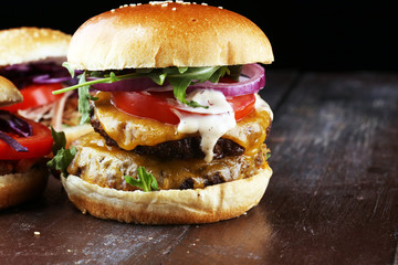 Tasty fresh meat burgers with salad and cheese. Homemade angus burger and Pulled pork sandwiches.