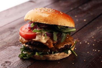 Tasty fresh meat burgers with salad and cheese. Homemade angus burger.
