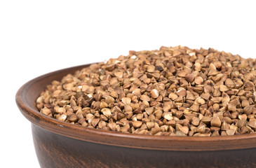 buckwheat in a clay plate on a white background