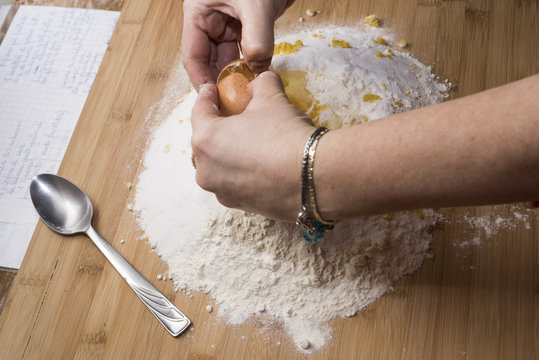 preparing a dessert on a wooden table with flour and eggs