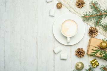 Fototapeta na wymiar Christmas composition in Scandinavian style. Christmas gifts, coffee with marshmallows, pine cones, spruce branches on a wooden white background. Flat lay. view from above, place to copy. Banner