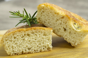 Rosemary focaccia in slices over wood