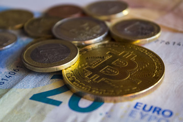 Golden bitcoin coin and euro money