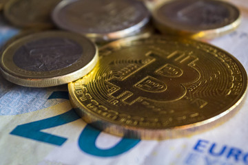 Golden bitcoin coin and euro money