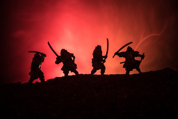 Silhouette of two samurais in duel. Picture with two samurais and sunset sky