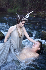 Fototapeta premium mermaid caught in the river a beautiful young man and now tries to seduce him, the guy looks at her with suspicion, it seems unexpected nothing good