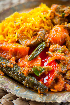 Indian Vegetable Curry with saffron rice on traditional metal plate.