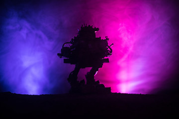Silhouette of Giant robot. Futuristic tank in action with foggy fire sky background