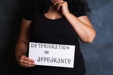 Sad woman worried and concerned about appearance deterioration. Overweight, beauty and health...