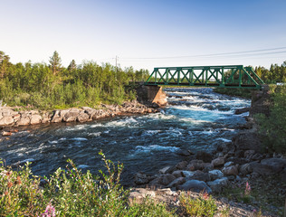 Fototapeta premium Picturesque panorama view of the railway bridge over the Rautas River near Rautas village in Kiruna municipality, Norrbotten, Sweden.