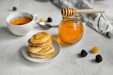 Home made American style pancakes with honey syrup
