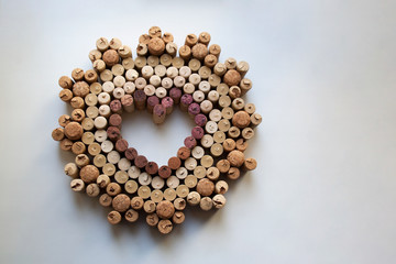 Wine corks heart shaped valentine badge isolated on white background from a high angle view
