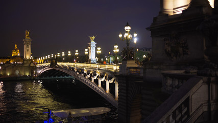 Romantic night scene of Alexandre III bridge across the Seine River in Paris
