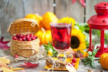 Obraz na płótnie Canvas hot winter or autumn drink with spices and wild rose berries, mulled wine, hot wine