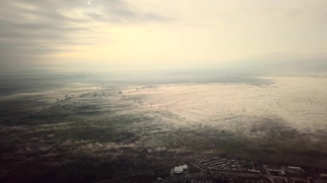 Flying over a concrete living apartment area in east Europa with many birds flying around the drone