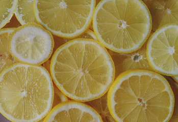 Fresh organic ripe lemons, lemon slices, top view